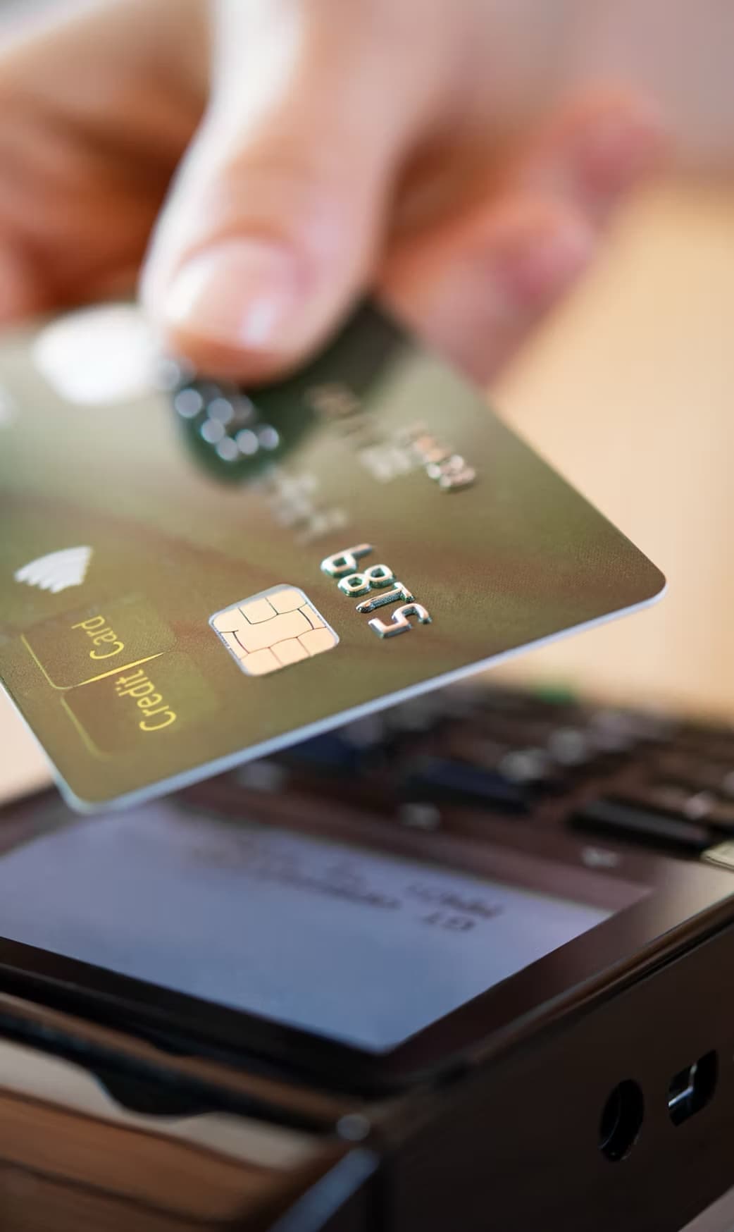 Customer tapping a credit card on a payment terminal